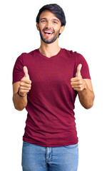 Poster - Handsome hispanic man wearing casual clothes success sign doing positive gesture with hand, thumbs up smiling and happy. cheerful expression and winner gesture.