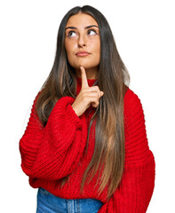 Wall Mural - Beautiful hispanic woman wearing casual clothes thinking concentrated about doubt with finger on chin and looking up wondering