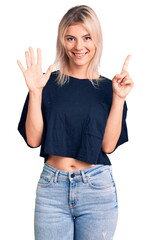 Sticker - Young beautiful blonde woman wearing casual t-shirt showing and pointing up with fingers number six while smiling confident and happy.