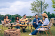 © Kawee - Group of diverse friend having outdoors camping party together in tent.