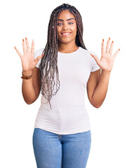 Canvas Print - Young african american woman with braids wearing casual clothes showing and pointing up with fingers number ten while smiling confident and happy.