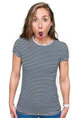 Canvas Print - Young blonde woman wearing casual clothes afraid and shocked with surprise expression, fear and excited face.