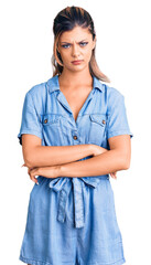 Canvas Print - Young beautiful woman wearing casual clothes skeptic and nervous, disapproving expression on face with crossed arms. negative person.