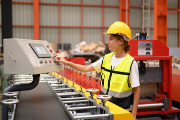 Latin woman engineer inspecting heavy machinery system in production line for manufacturing safety. Female technician doing repair service. Maintenance machine equipment in metalwork factory concept.