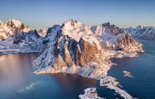 Aerial view at the Lofoten islands, Norway. Mountains and sea during sunset. Natural landscape from air at the drone. Norway at the winter time