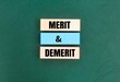 colored paper with the words Merit and Demerit. noun. a quality deserving blame. Merit, demerit and its retributions at the level of the individual.