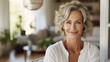 © mariiaplo - Capturing the essence of a beautiful mature woman in the warm ambiance of her living space.