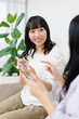 © Paylessimages - スマホを見せている女性