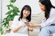 © Paylessimages - スマホを見せている女性