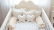 White wooden baby crib with pillows