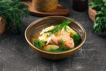 Wall Mural - Bowl of appetizing salmon soup with vegetables