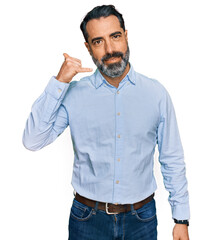 Sticker - Middle aged man with beard wearing business shirt smiling doing phone gesture with hand and fingers like talking on the telephone. communicating concepts.