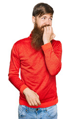 Poster - Redhead man with long beard wearing casual clothes looking stressed and nervous with hands on mouth biting nails. anxiety problem.