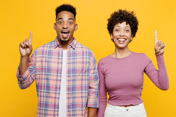 Wall Mural - Young smart couple two friend family man woman of African American ethnicity wear purple casual clothes together holding index finger up with great new idea isolated on plain yellow orange background