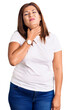 Middle age latin woman wearing casual white tshirt touching painful neck, sore throat for flu, clod and infection