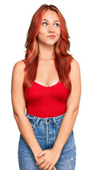 Canvas Print - Young redhead woman wearing casual clothes smiling looking to the side and staring away thinking.