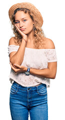 Wall Mural - Beautiful caucasian woman wearing summer hat thinking looking tired and bored with depression problems with crossed arms.