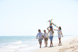 © Blue Jean Images - Family playing at the beach