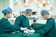 © Blue Jean Images - Three surgeons in an operating room