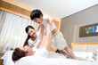 © Blue Jean Images - Portrait of a young family on a bed