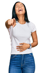 Sticker - Beautiful hispanic woman wearing casual white tshirt laughing at you, pointing finger to the camera with hand over body, shame expression