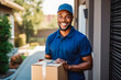 Older mature handsome smiling delivery mailman person delivering parcel cardboard box in front of a house door. Afro american in uniform.