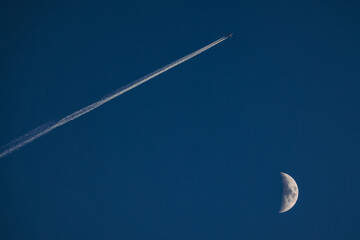 Wall Mural - blue sky with moon and flying airplane