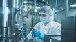 © Ai Studio - Woman in a sterile suit operating machinery in a pharmaceutical manufacturing facility