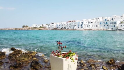 Wall Mural - Naoussa typical white street leading to sea with sunshine, small village on Paros island, Greece