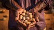 A closeup shot of a farmer holding groundnuts 