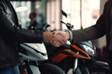 Fototapeta  - Happy customer shaking hands with sales agent after a successful motorcycle buying