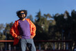 © Teran - Mexican Latino man with curly hair and beard in a park in a proud pose