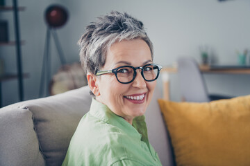 Portrait of positive person senior woman wearing khaki shirt toothy smile intelligent business lady looking at you isolated in home office