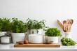 A kitchen counter with pots of plants and utensils. Perfect for adding a touch of nature to your cooking space