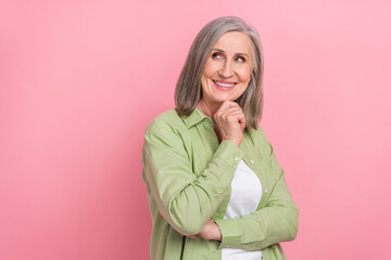 Sticker - Photo of attractive charming hr director senior woman touch chin minded confident look empty space isolated on pink color background