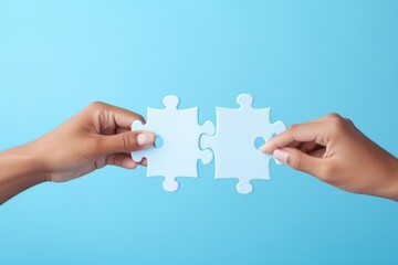 Poster - Two hands holding two pieces of a puzzle. Suitable for illustrating teamwork, problem-solving, collaboration, or completing a puzzle metaphorically