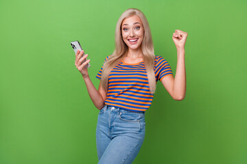 Wall Mural - Photo of overjoyed cheerful girl wear trendy clothes rejoice success blog popularity isolated on green color background