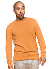 Poster - Hispanic adult man wearing casual winter sweater afraid and shocked with surprise expression, fear and excited face.