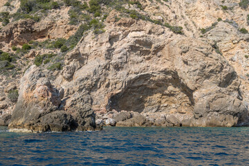 Wall Mural -  igneous rock hole in cliffs at Uomo cape, Argentario, Italy