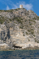 Wall Mural - old tower ruin on steep rocky cliffs at Maddalena  cape, Argentario, Italy