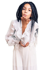 Poster - Cute african american girl wearing casual white tshirt looking at the camera blowing a kiss with hand on air being lovely and sexy. love expression.