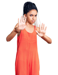 Poster - Cute african american girl wearing casual clothes moving away hands palms showing refusal and denial with afraid and disgusting expression. stop and forbidden.