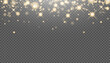 Christmas background made of golden glitter lights. Glowing gold sparkles. The glitter of golden dust in the rays of light. Abstract festive background
