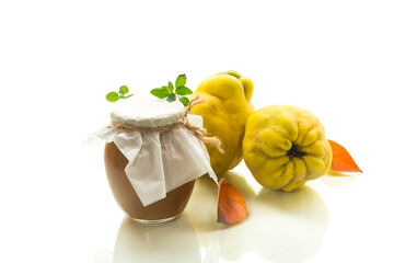 Wall Mural - Ripe quince fruit with jam in a glass jar isolated on a white background.