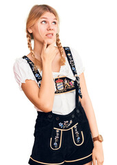 Wall Mural - Young beautiful blonde woman wearing oktoberfest dress thinking worried about a question, concerned and nervous with hand on chin