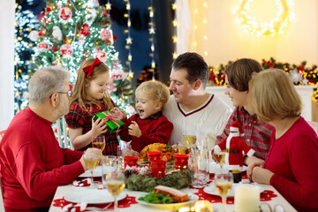 Poster - Family with kids having Christmas dinner at tree