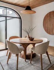 Round wood slab dining table and curved chairs in small room. Japandi style home interior design of modern dining room