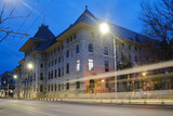 Fototapeta  - Bucharest town hall building exterior with car trail at twilight. Administration landmark in Romania capital city.