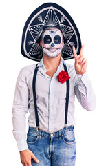 Poster - Man wearing day of the dead costume over background showing and pointing up with fingers number two while smiling confident and happy.