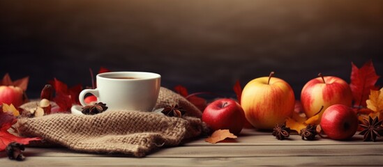 Fototapete - Autumn still life a cup of tea a fresh crop of red and green apples cones cinnamon sticks red mountain ash on a textured knitted fabric and an old wooden table Autumn autumn mood and comfort